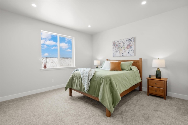 bedroom featuring light carpet, recessed lighting, and baseboards