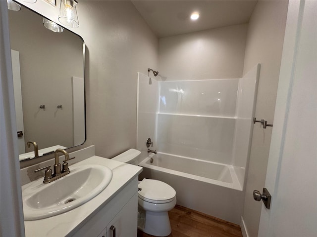 bathroom with tub / shower combination, vanity, toilet, and wood finished floors