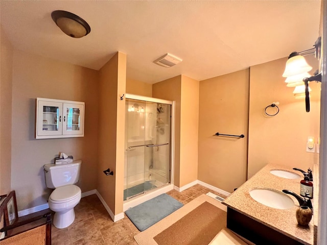 bathroom featuring visible vents, a shower stall, toilet, and a sink