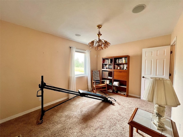 exercise area featuring an inviting chandelier, baseboards, and carpet floors