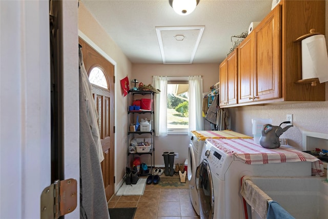 laundry room featuring washer and dryer, light tile patterned floors, cabinet space, and baseboards