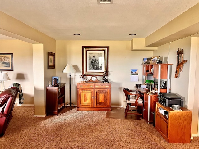 sitting room with baseboards, light carpet, and a textured ceiling