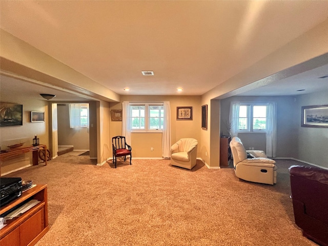 sitting room featuring visible vents, plenty of natural light, carpet flooring, and baseboards