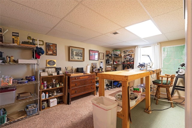 home office with carpet, a paneled ceiling, and visible vents