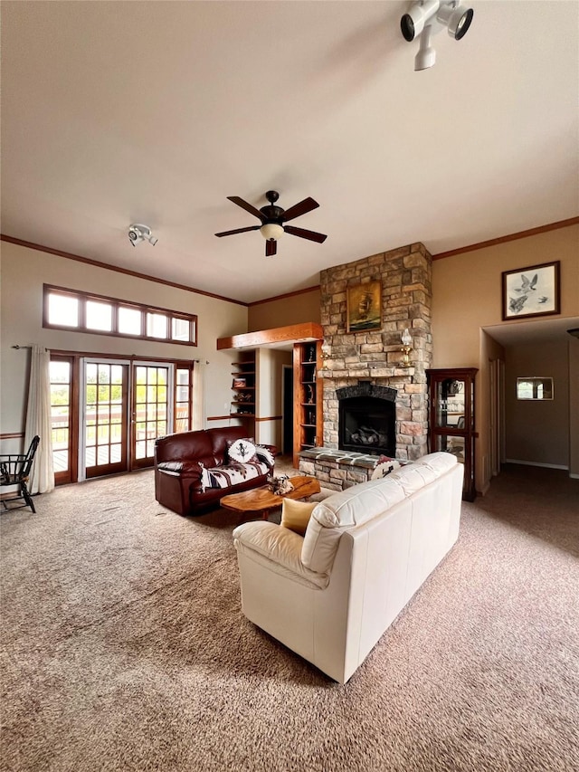 carpeted living room with ceiling fan, a fireplace, and ornamental molding