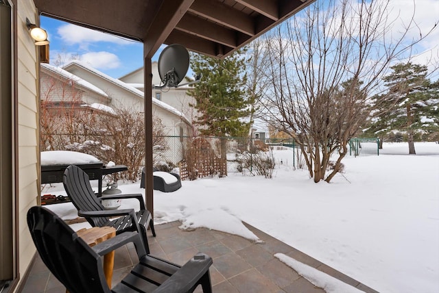 snow covered patio with fence