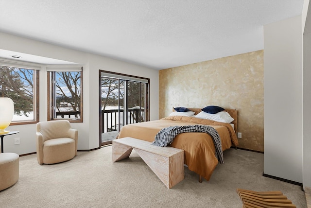 carpeted bedroom featuring access to outside, baseboards, and a textured ceiling