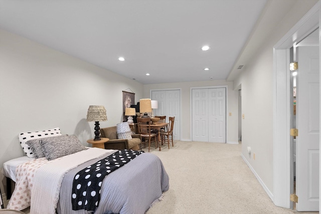 bedroom featuring multiple closets, recessed lighting, carpet floors, and baseboards