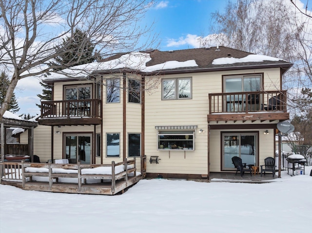 snow covered house with a balcony