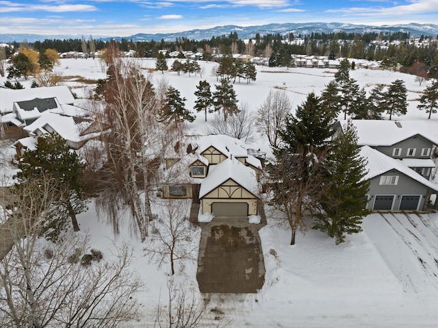 snowy aerial view with a mountain view