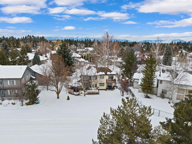 snowy aerial view with a residential view