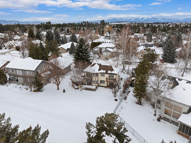 snowy aerial view with a residential view and a mountain view