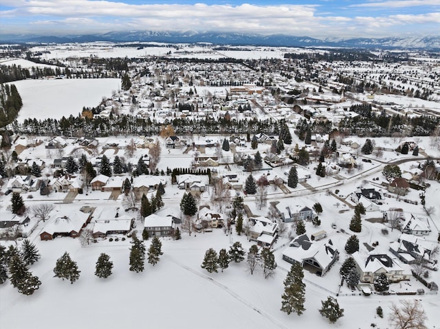 snowy aerial view featuring a residential view