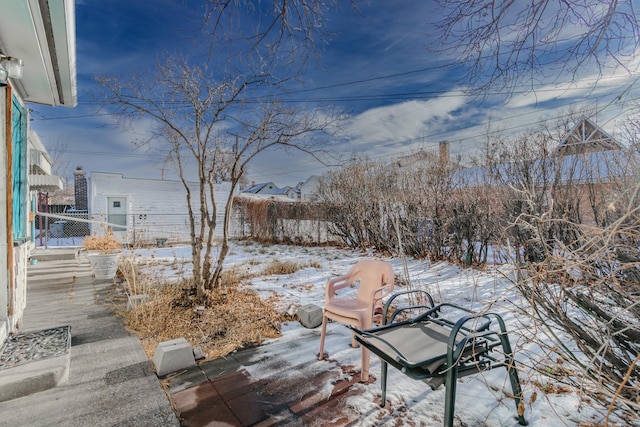 yard layered in snow with fence