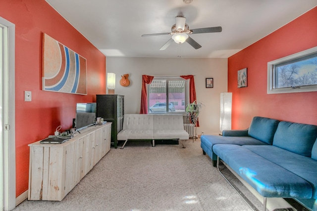 living room featuring a ceiling fan and light colored carpet