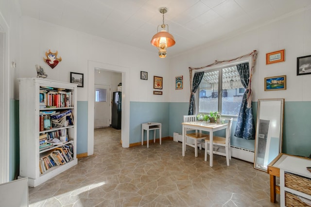 dining space with a baseboard heating unit