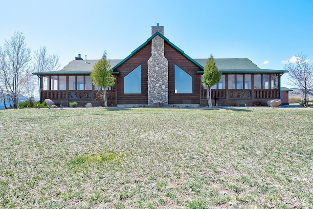 3 Paradise Ridge Rd, Clancy, MT 59634 - rear view of house featuring a sunroom, a chimney, and a lawn
