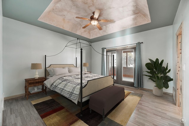 3 Paradise Ridge Rd, Clancy, MT 59634 - bedroom with a raised ceiling, light wood-style flooring, access to exterior, baseboards, and ceiling fan