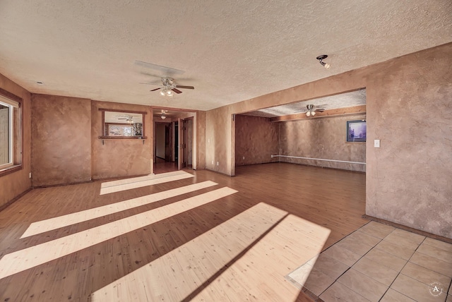 3 Paradise Ridge Rd, Clancy, MT 59634 - unfurnished room with a ceiling fan, a textured ceiling, wood finished floors, and plenty of natural light