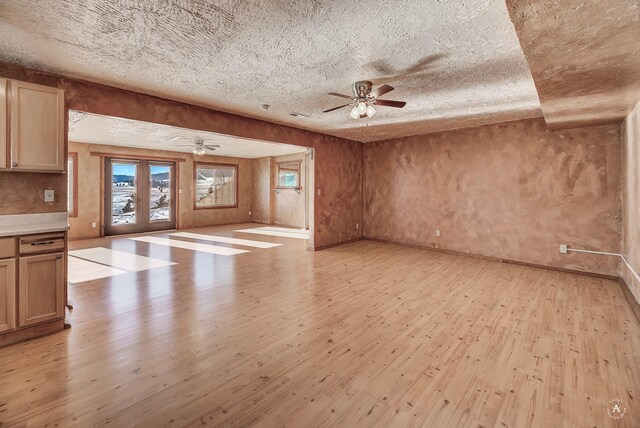 3 Paradise Ridge Rd, Clancy, MT 59634 - unfurnished living room with light wood-style flooring, ceiling fan, a textured ceiling, and baseboards