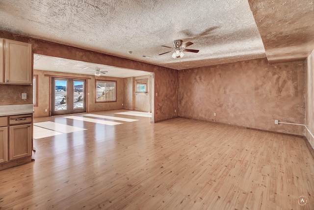3 Paradise Ridge Rd, Clancy, MT 59634 - unfurnished living room featuring light wood-type flooring, a ceiling fan, and a textured ceiling