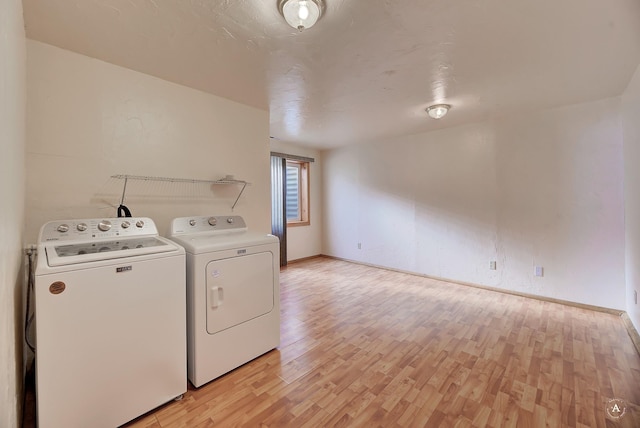 3 Paradise Ridge Rd, Clancy, MT 59634 - clothes washing area featuring washing machine and clothes dryer, light wood-style flooring, and baseboards