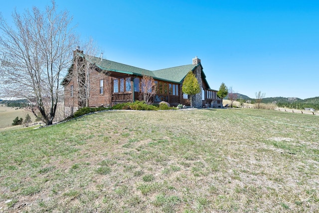 3 Paradise Ridge Rd, Clancy, MT 59634 - view of front facade featuring a chimney and a front lawn