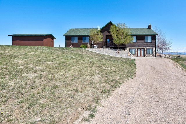 3 Paradise Ridge Rd, Clancy, MT 59634 - view of front of home featuring a chimney, a front yard, and dirt driveway