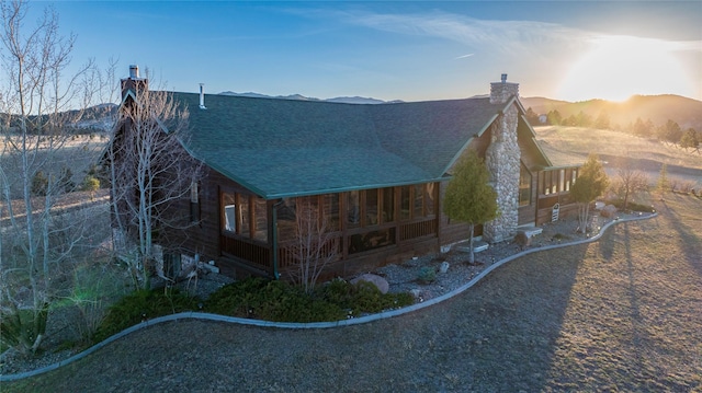 3 Paradise Ridge Rd, Clancy, MT 59634 - view of property exterior featuring a chimney, a shingled roof, and a mountain view