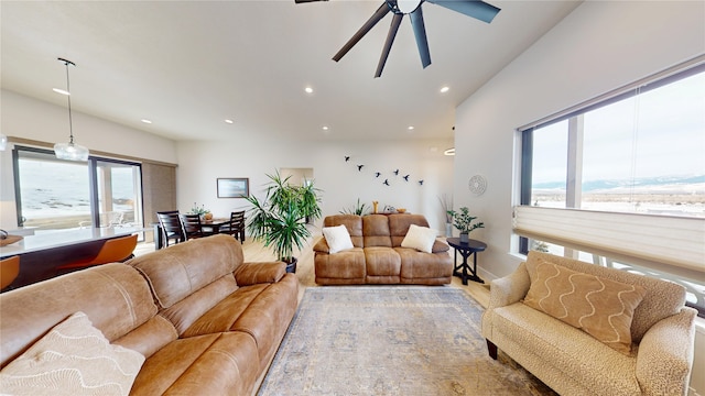 living area with wood finished floors, vaulted ceiling, a ceiling fan, and recessed lighting