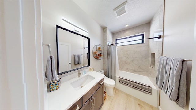 full bathroom with shower / tub combo with curtain, visible vents, toilet, a textured ceiling, and vanity