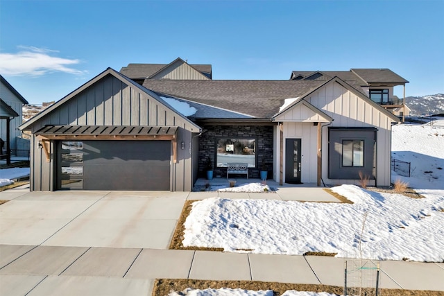 view of front of house with an attached garage, a shingled roof, board and batten siding, and concrete driveway