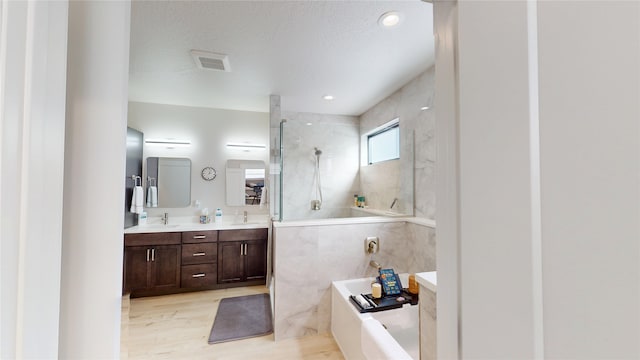 bathroom with a garden tub, a sink, wood finished floors, visible vents, and walk in shower