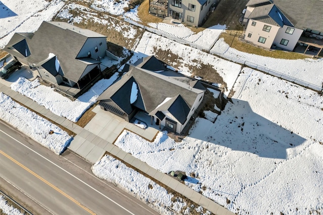 snowy aerial view with a residential view