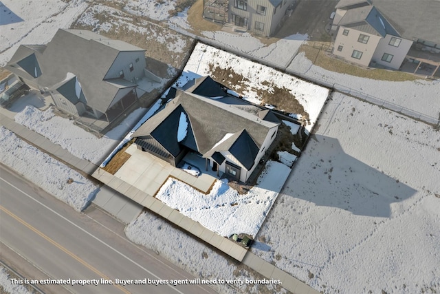 snowy aerial view featuring a residential view