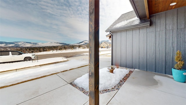 snow covered patio featuring a mountain view