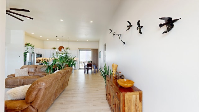 living room featuring light wood-type flooring and recessed lighting