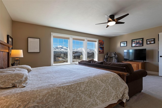 bedroom featuring baseboards, a ceiling fan, and carpet flooring