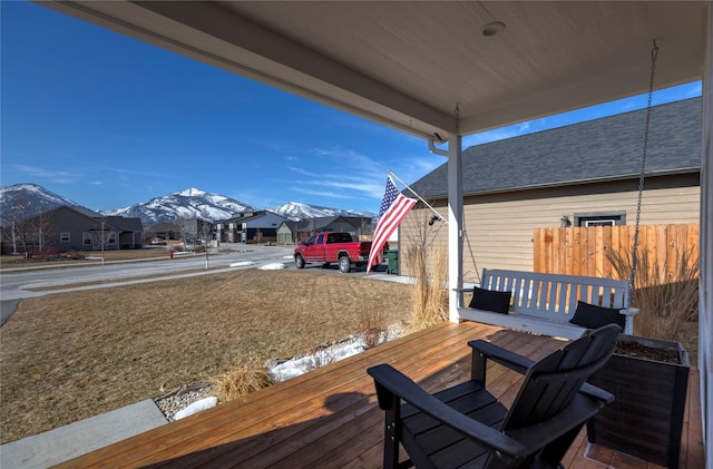 deck with fence and a mountain view