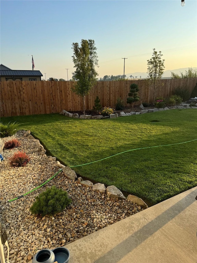 yard at dusk featuring fence