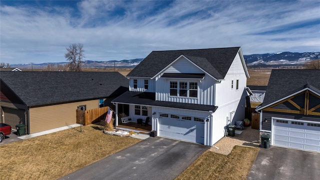 view of front of home featuring driveway, board and batten siding, an attached garage, and a mountain view