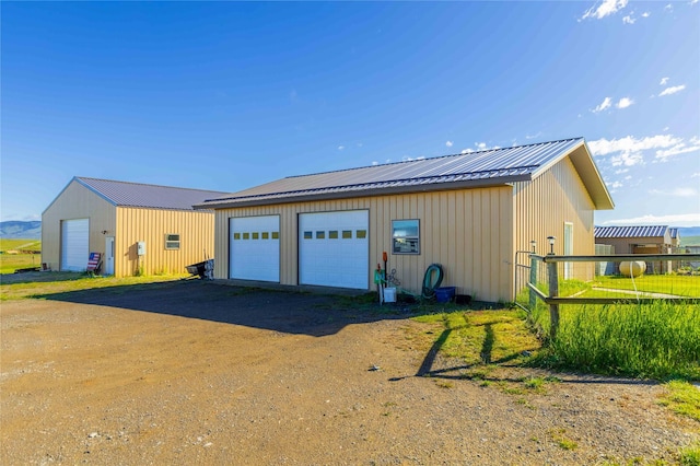 detached garage featuring fence