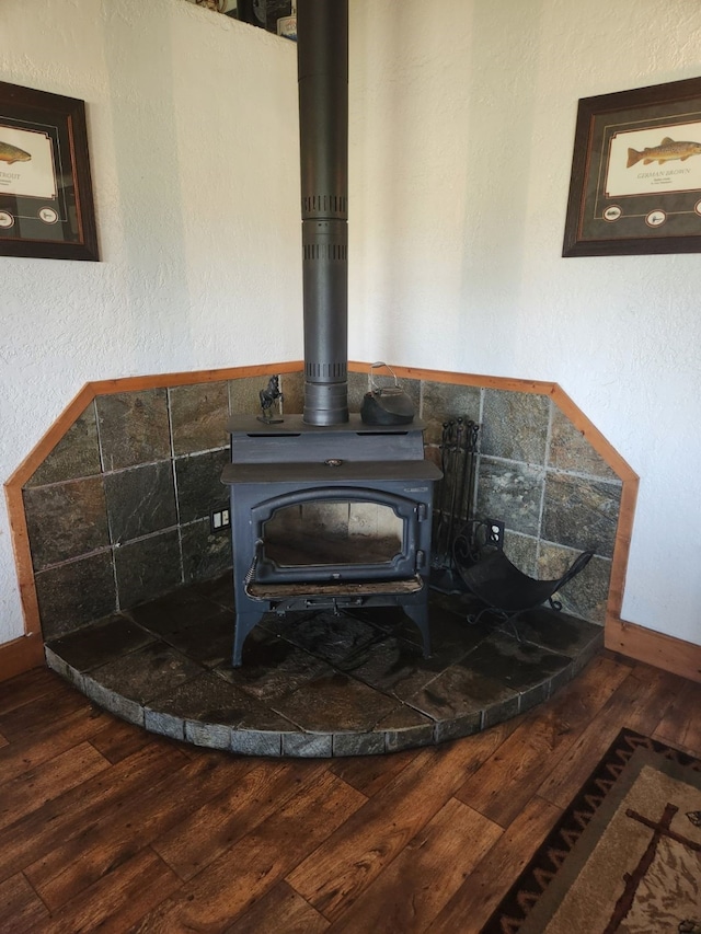 details with a wood stove and wood finished floors