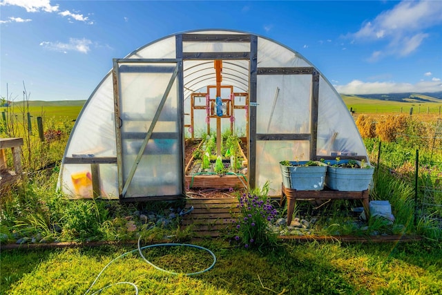 view of greenhouse featuring a rural view