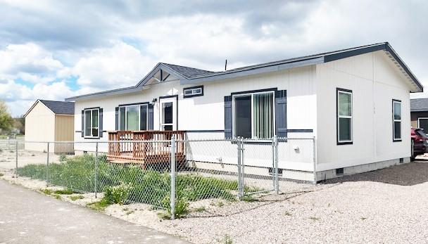 view of side of property with crawl space and a fenced front yard