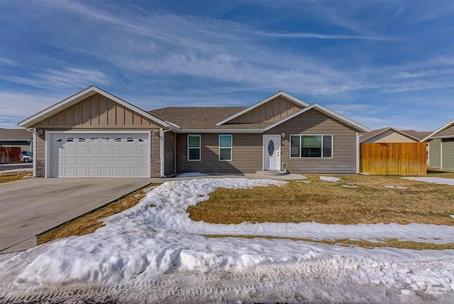 ranch-style house with an attached garage, fence, board and batten siding, and concrete driveway