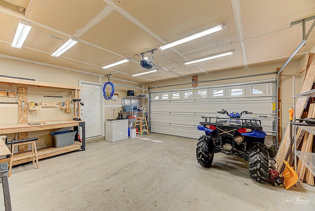 garage featuring a garage door opener and a workshop area