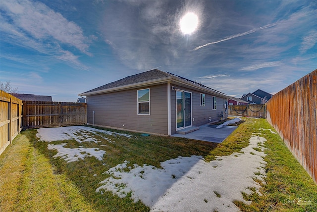 back of house with a patio area, a fenced backyard, and a lawn