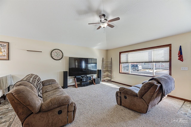 living room with a ceiling fan, carpet flooring, vaulted ceiling, and baseboards