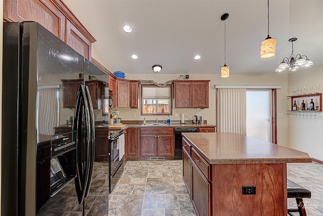 kitchen with a breakfast bar area, a center island, hanging light fixtures, black appliances, and a sink